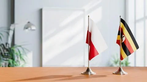 FLAGS OF POLAND AND UGANDA ON TABLE Stock Photos