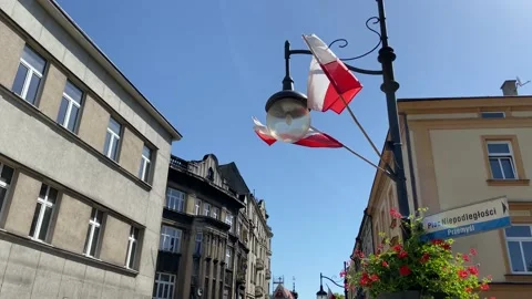 Flags of Poland waving in the wind. in city, Celebrating Polish National Flag Stock Footage 210143729