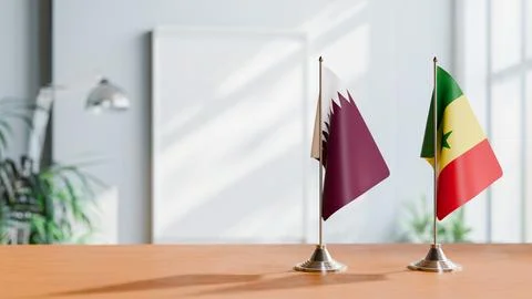 FLAGS OF QATAR AND SENEGAL ON TABLE Stock Photos