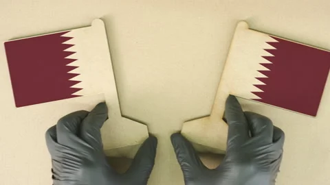 Flags of Qatar made of recycled paper on the cardboard table Stock Footage 143259558