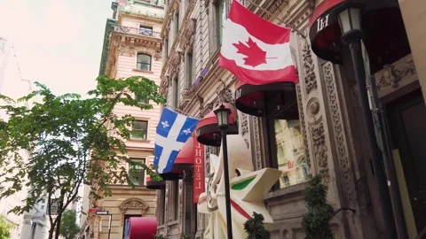 The flags of Quebec and Canada fly on the historic building of the L'Hotel. Stock-Footage 318188451