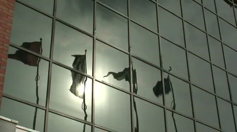 Flags reflecting in windows of a glass building 스톡 동영상 65104