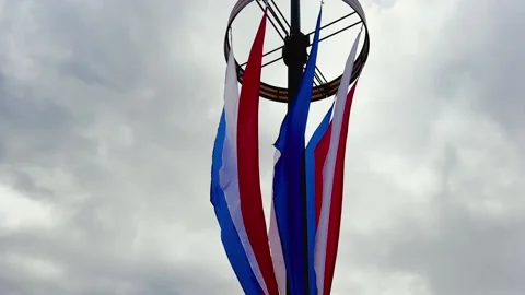The flags of Russia flutter in the wind on a cloudy day against the grey sky Stock Footage 196159975