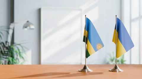 FLAGS OF RWANDA AND UKRAINE ON TABLE Stock Photos