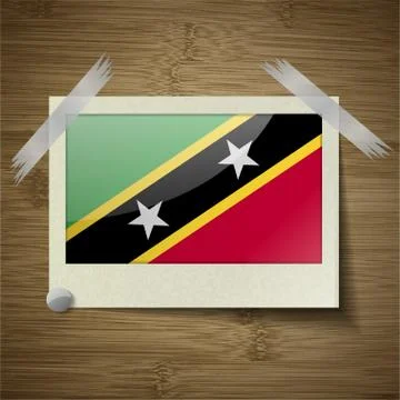 Flags Saint Kitts Nevis at frame on wooden texture. Vector Stock Illustration
