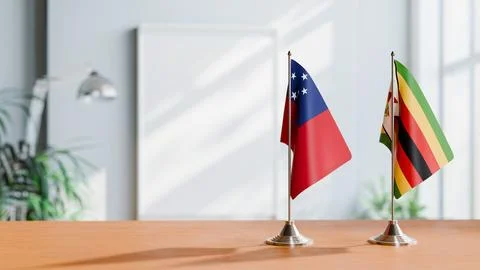 FLAGS OF SAMOA AND ZIMBABWE ON TABLE Stock Photos