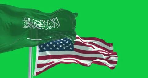 Flags of Saudi Arabia and The US waving in the wind isolated on green backg.. Video stock 309421810