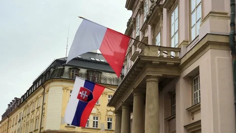 Flags of Slovakia and Bratislava waving in the wind on the building of City Hall Stock Footage 86293264