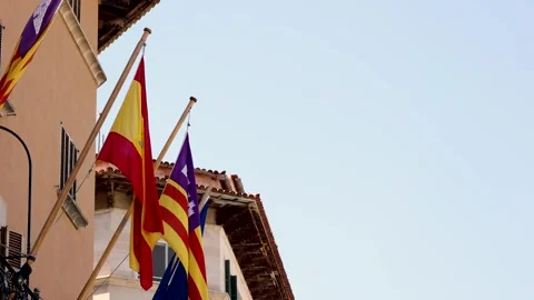 Flags of Spain and Mallorca in the town of Sller moving with the wind Stock Footage 294520057