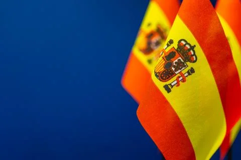 Flags of Spain with dark blue background empty space for your text on left. Stock Photos