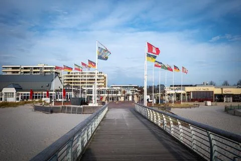 Flags stand at the beginning of the pier of Groemitz Stock Photos