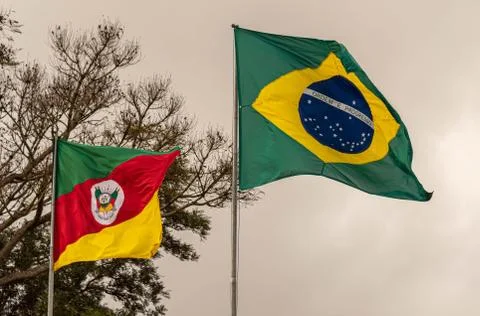Flags of the State of Rio Grande do Sul and Brazil flying on a cloudy day Fotos Stock
