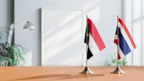 FLAGS OF SUDAN AND THAILAND ON TABLE Stock Photos