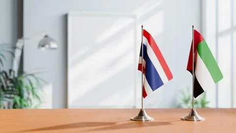 FLAGS OF THAILAND AND UAE ON TABLE Stock Photos