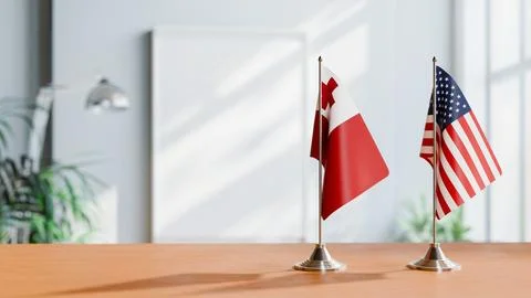 FLAGS OF TONGA AND USA ON TABLE Stock Photos