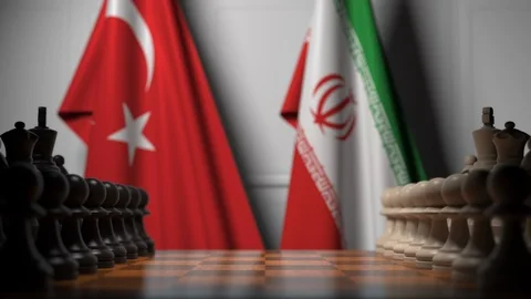 Flags of Turkey and Iran behind pawns on the chessboard. Chess game or political Stock Footage 116597448