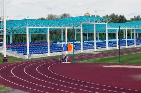 Flags at the turn of a stadium treadmill Stock Photos