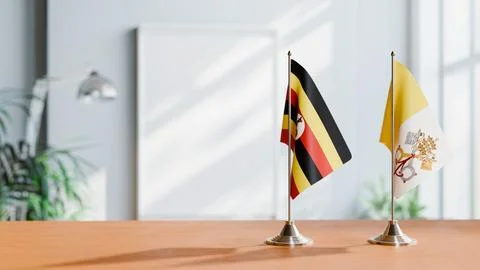 FLAGS OF UGANDA AND VATICAN ON TABLE Stock Photos