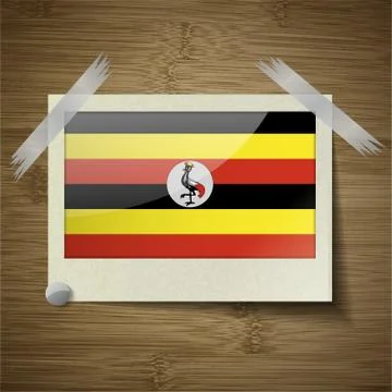 Flags Uganda at frame on wooden texture. Vector Stock Illustration