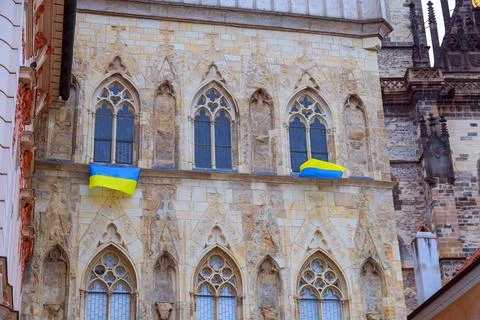 The flags of Ukraine are attached to the windows of an architectural building in Stock Photos