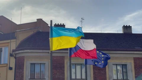 The flags of Ukraine, Czech Republic and EU flutter together in the wind. Prague Stock Footage 190619073