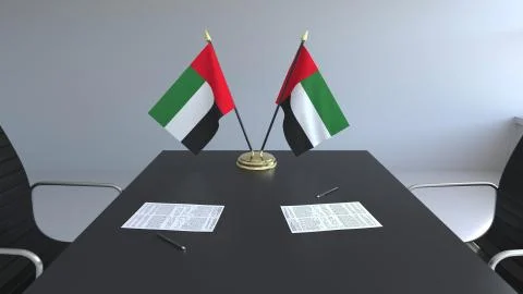 Flags of the United Arab Emirates UAE and papers on the table. Negotiations and 스톡 일러스트