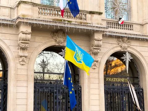 Flags of unity and pride adorn a historic building in the heart of Europe Stock Photos