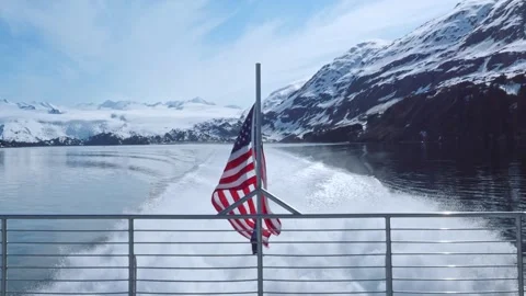 Flags of US and Alaska on back of boat in Backstone Bay, near Whittier, Alaska Stock Footage 244550559