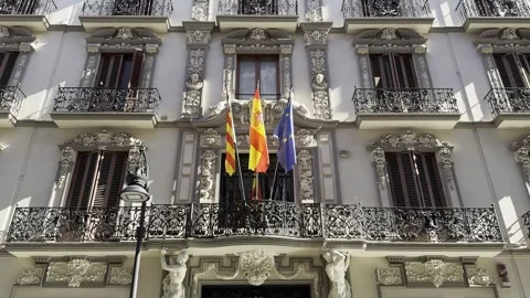 Flags of Valencia, Spain and EU flying on balcony of building in Valencia Stock Footage 255289194
