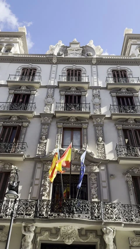 Flags of Valencia, Spain, EU flying on balcony of building in Valencia. Vertical Stock Footage 255289204