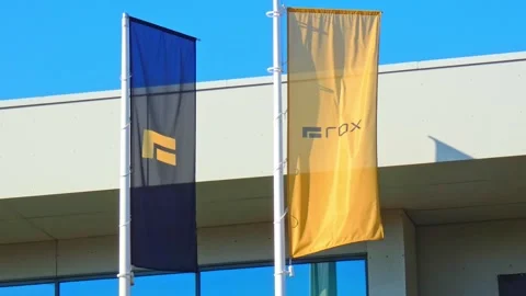 Flags wave from a building in bright sunlight during a clear day Stock Footage 337531586