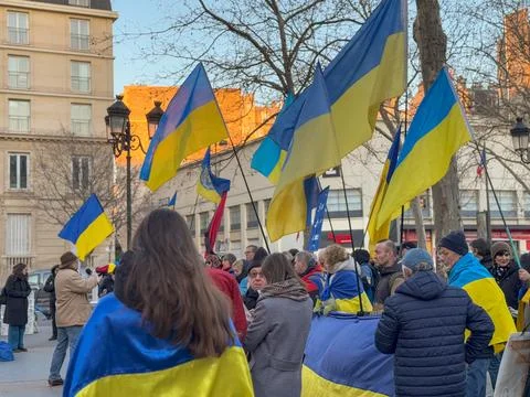Flags wave in unity, symbolizing hope and resilience in the crowd Stock Photos