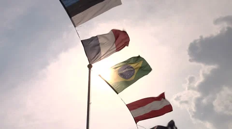 Flags waving against the sun  Stock Footage 38519516