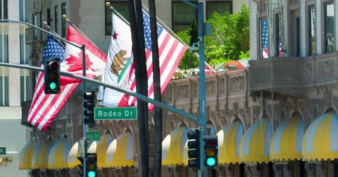 Flags waving at Beverly Wilshire Hotel landmark in Los Angeles 4K RAW Stock Footage