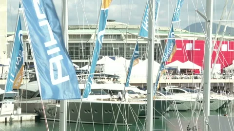 Flags waving on docked boats during Genoa Boat Show  Stock Footage 43317168