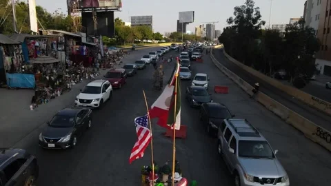 Flags waving in Tijuana at Border crossing queue Video stock 279046572