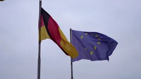 Flags waving in unison against a cloudy sky in Germany Stock Footage 320339450
