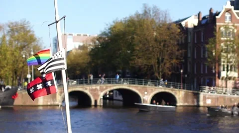 Flags waving in the wind with Amsterdam in the background Stock Footage 61583649