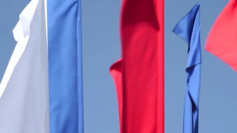 Flags waving in the wind. Colorful fabrics on the street Stock Footage 76836002