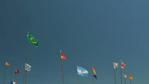 Flags waving in the yard of a small restaurant in Cabo Polonio. Stock Footage 87721777