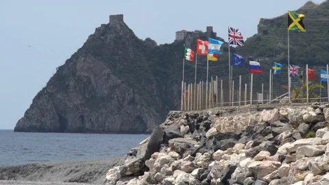 Flags in the wind of a camping on the seashore Stock Footage 107529673
