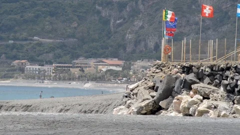 Flags in the wind of a camping on the seashore Stock Footage 107532289