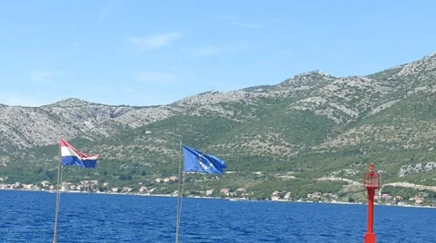 Flags in Wind on Sea Coast Stock Footage 54903132