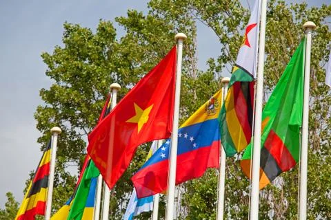 Flags of the world happily blowing in the wind . Stock Photos