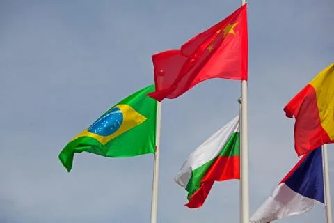 Flags of the world happily blowing in the wind . Stock Photos