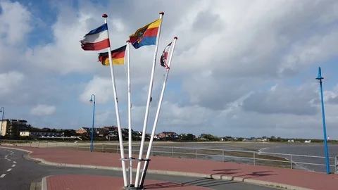 Flagstaffs with flags of Germany, Schleswig-Holstein, Amrum are waving in Stock Footage 108521237