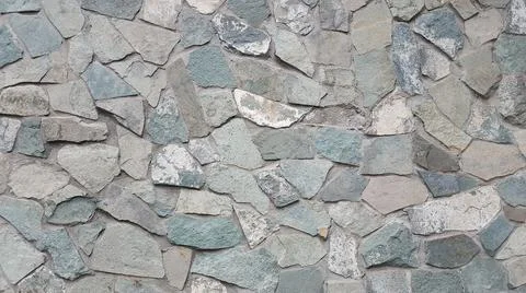 Flagstone in the form of a combination of various gray stone slabs background Stock Photos