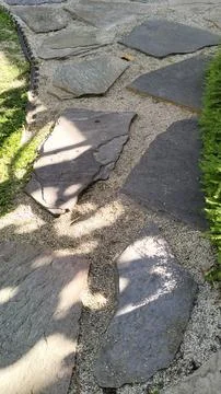 Flagstone stepping stone pathway  with  pebbles. Stock Photos