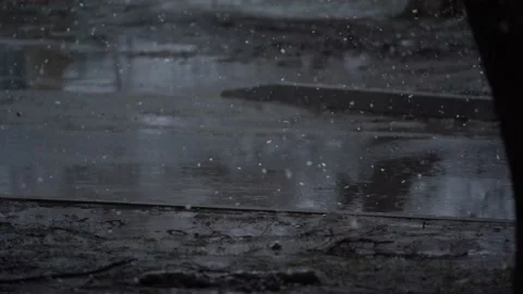 Flakes of snow fall into a puddle in winter. reflection from a puddle. beautiful Stock Footage 151462545