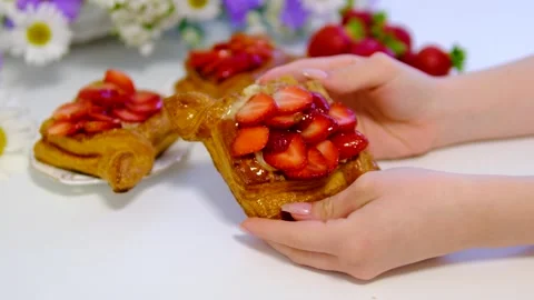 Flaky puff pastry filled with fresh strawberries and strawberry jam on white Stock Footage 344893953